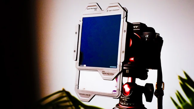 Monitor and camera rig setup on tripod with studio lighting