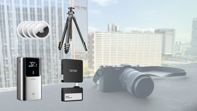 Photography equipment collection including smartphone gimbal, wireless microphone system, tripod, camera, and lens displayed against urban cityscape backdrop