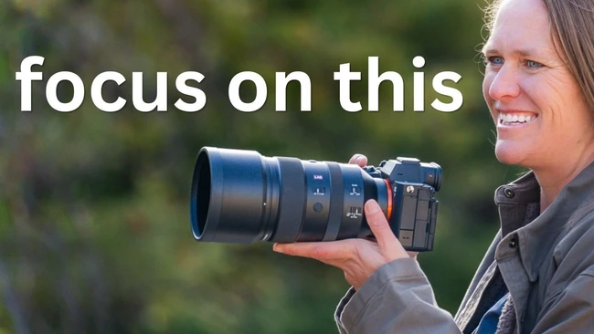 Photographer holding a telephoto lens with text overlay reading "focus on this"