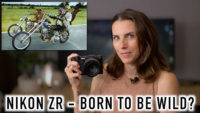 Woman holding Nikon ZR camera with inset image of motorcycle stunts