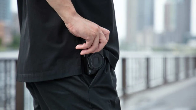 Man in black clothing with empty wallet pocket in urban setting