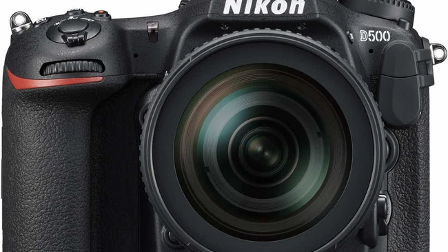 Nikon D500 DSLR camera with 18-140mm kit lens on white background