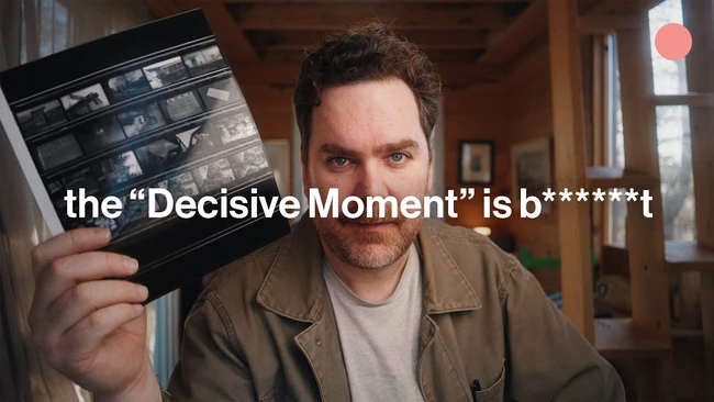 Man holding a contact sheet with text overlay about decisive moments in photography