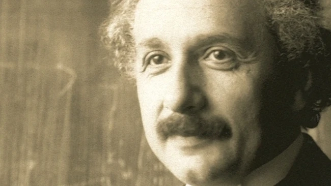 Portrait photograph of a man with distinctive mustache in sepia tones