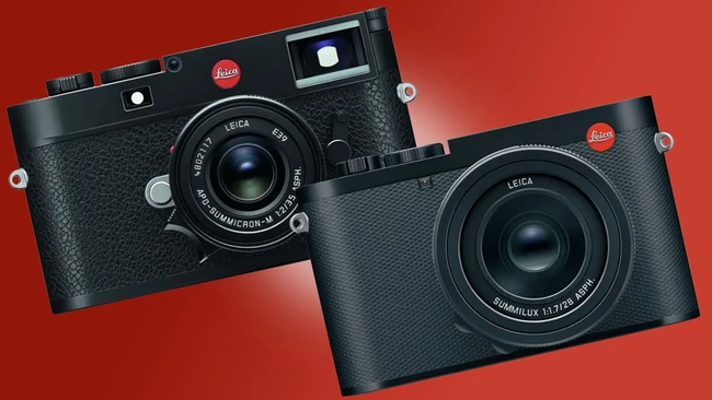 Two Leica rangefinder cameras displayed against a red background