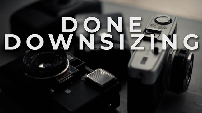Graphic with text "DONE DOWNSIZING" overlaid on vintage cameras in black and white