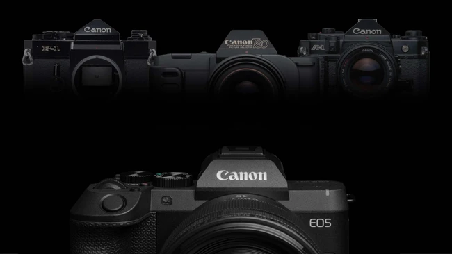 Canon EOS mirrorless camera displayed front and center with three vintage Canon film cameras arranged above