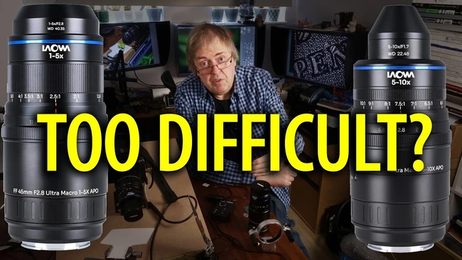 Man in blue plaid shirt comparing two Laowa macro lenses displayed on table