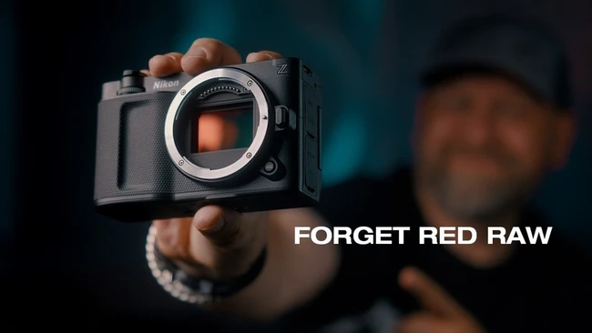 Photographer holding a Fujifilm mirrorless camera with sensor visible, text reads 'FORGET RED RAW'