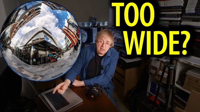 Man gesturing at a laptop and camera beside a fisheye-distorted city street inset, with yellow text reading 'TOO WIDE?'