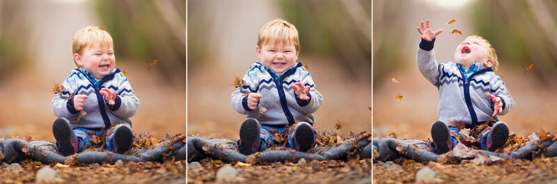 happy boy playing in autumn leaves