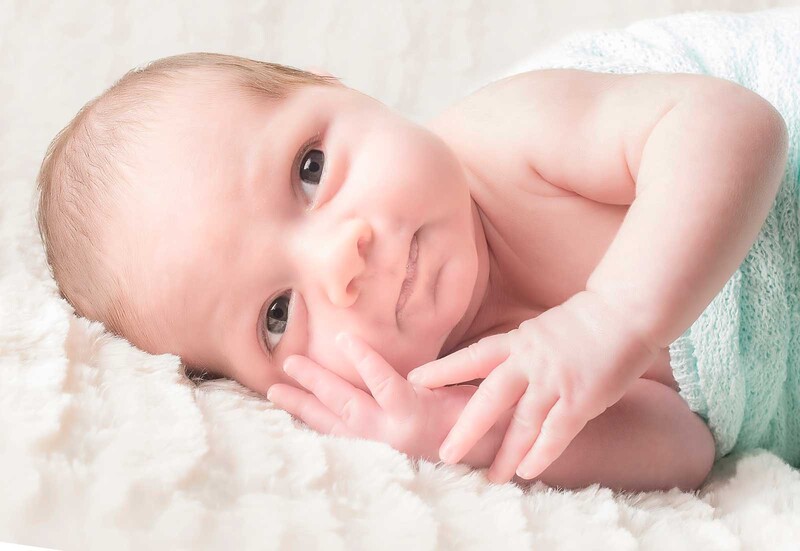 newborn baby on blanket