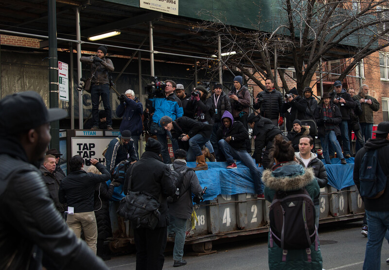 News photographers gain some height by standing on a dumpster on Saturday, Dec. 13, 2014 at the Millions March NYC. With the layoffs of so many photojournalists, there will be less eyes on key moments in New York City. Photo by Chelsea Katz.