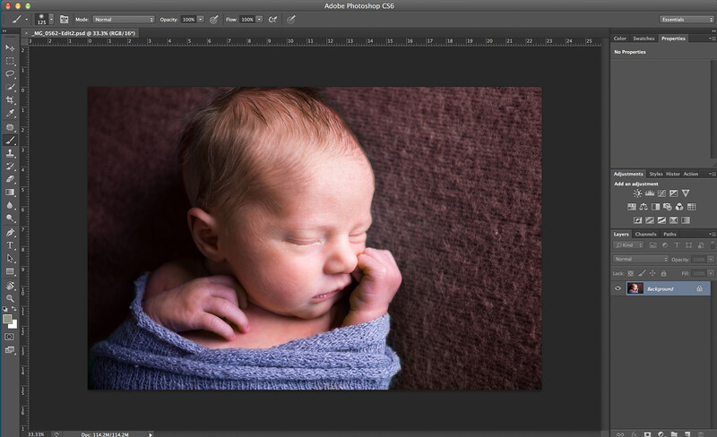 newborn sleeping on blanket