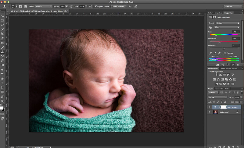 newborn sleeping in a teal wrap