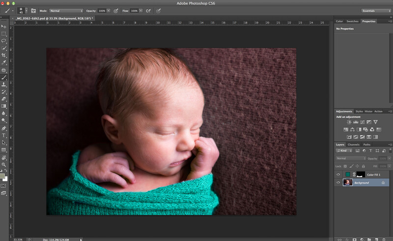 newborn sleeping in teal wrap