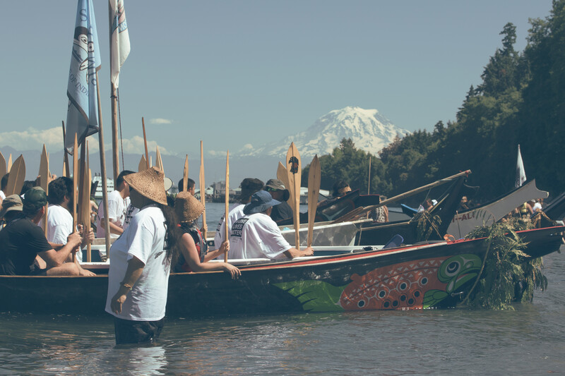 Tribal canoes landing in front or Mt Reiner, Washington State 