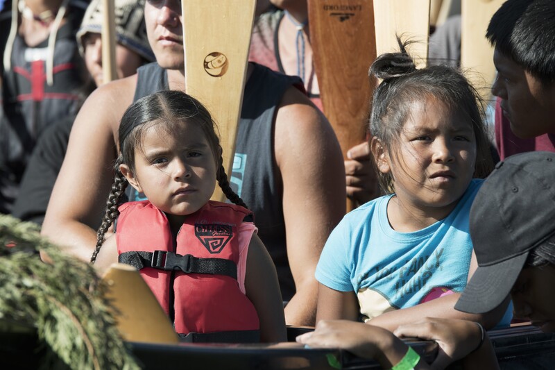 Two young native girls sitting patiently in the canoe. Photo by Gabrielle Colton
