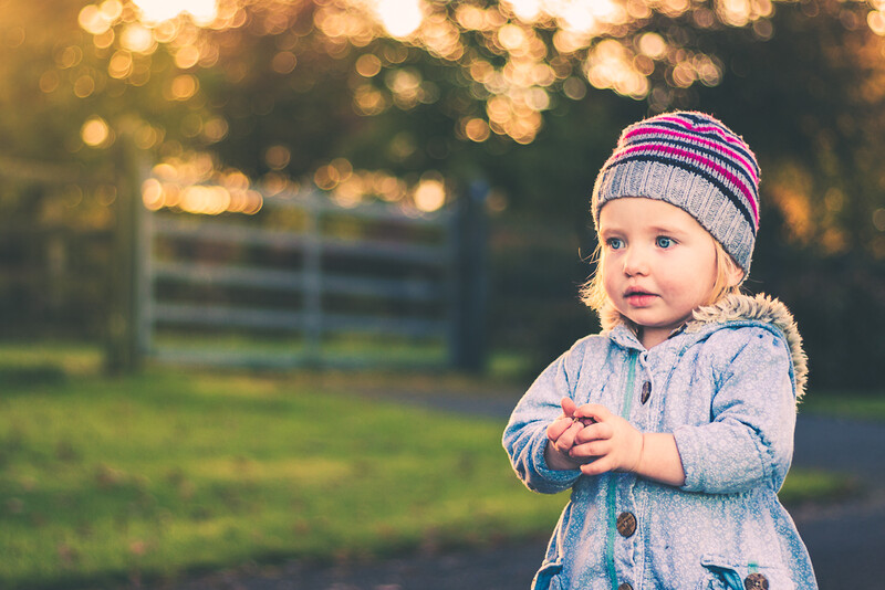 cute little girl. photograph of toddler. shallow depth of field. child portrait. outdoor portrait of little girl in warm coat.