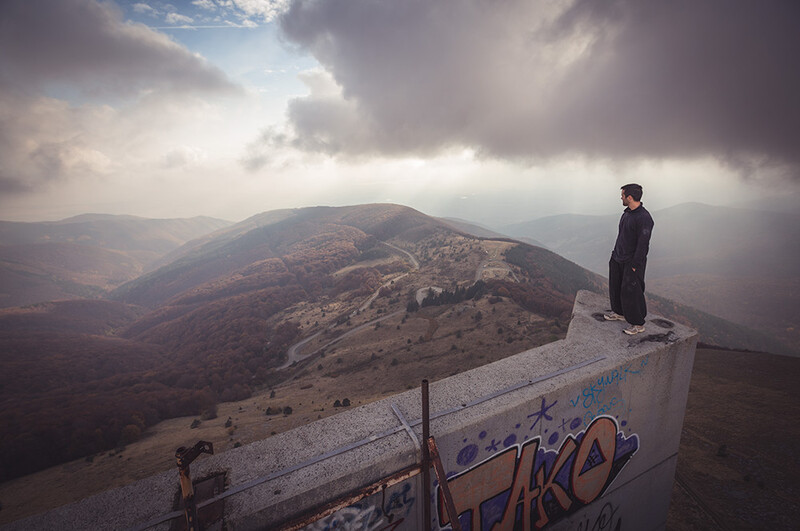 Thomas Couetdic atop Buzludzha, the former Communist Party headquarters of Bulgaria. Image by Andy Day