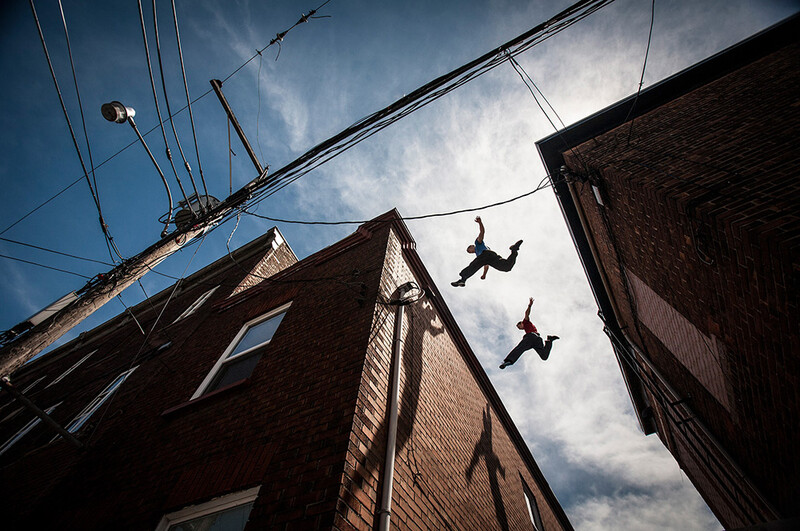 Chris Rowat and Chris Keighley jumping between rooftops in Quebec. Image by Andy Day.
