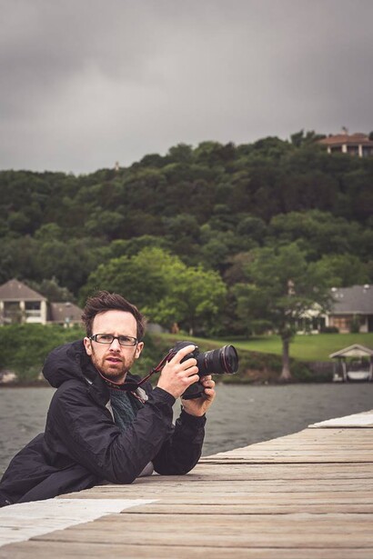 Writer Andy Day wading in water to get a lower shot