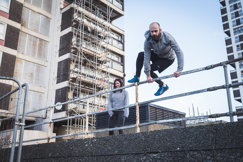A parkour athlete vaulting a rail. Andy Day.