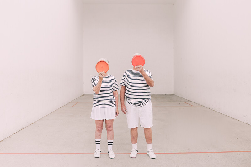 An elderly couple in sports wear.