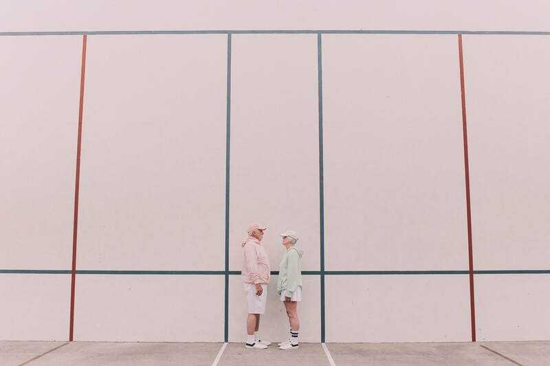 An elderly couple in sports wear.