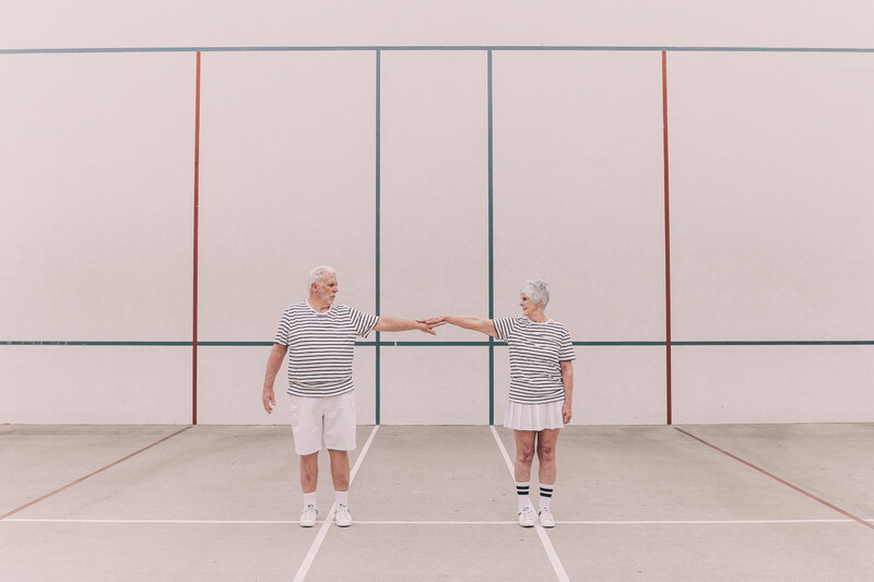 An elderly couple in sports wear. 