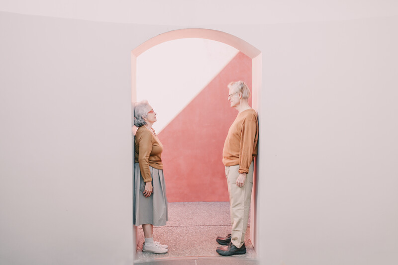 Elderly couple in an archway.