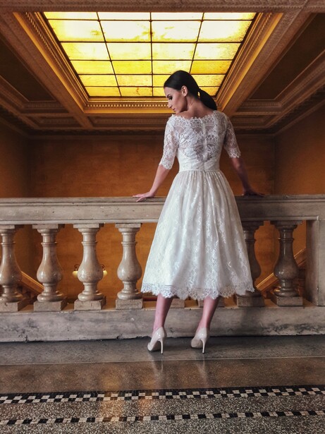 Bride with a short wedding dress near a staircase.