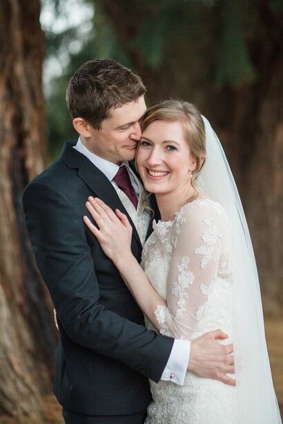 Bride and groom in a park.
