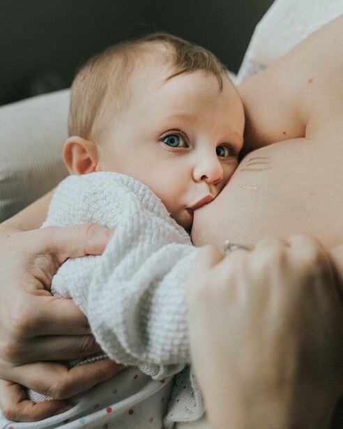 A newborn being breastfed.
