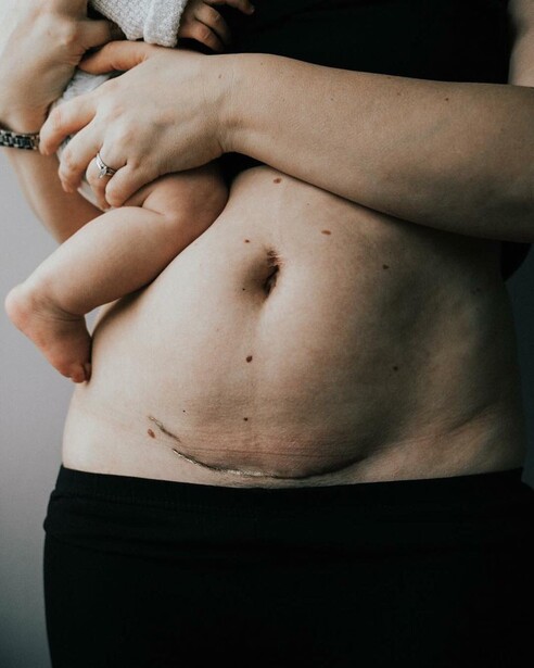 A mother holding her newborn.