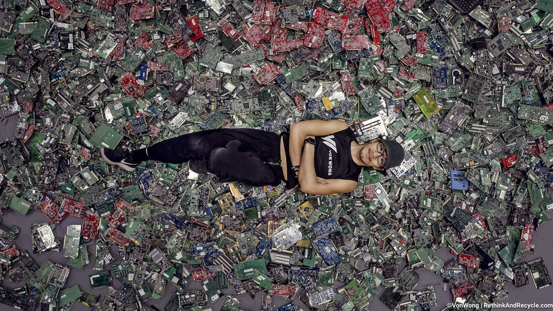 Image of Benjamin Von Wong posing on top of 4100 pounds of e-waste