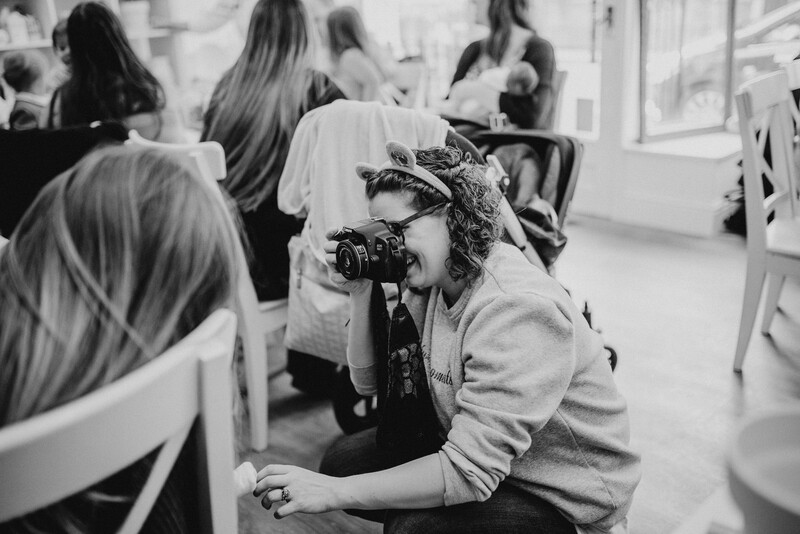 Female photographer documenting a baby.