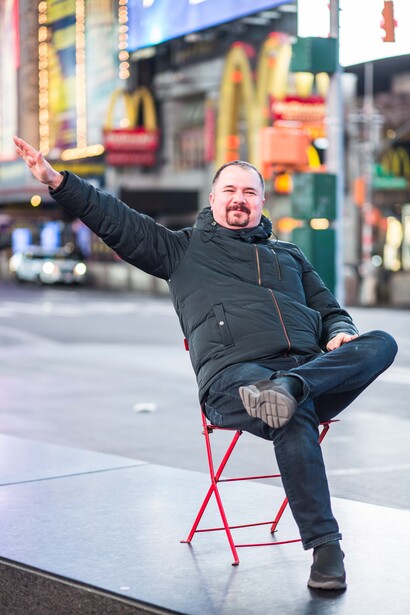A man sat on a chair in Times Square