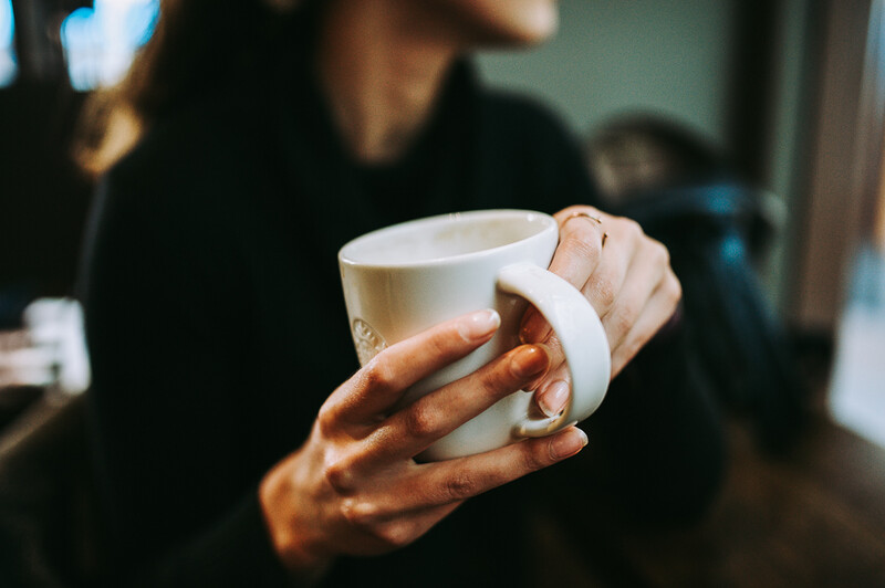 Girl holding a coffee cup.
