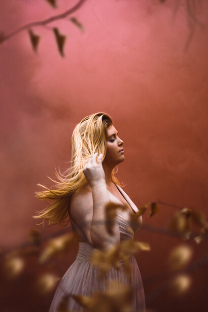 Girl in front of a red wall.
