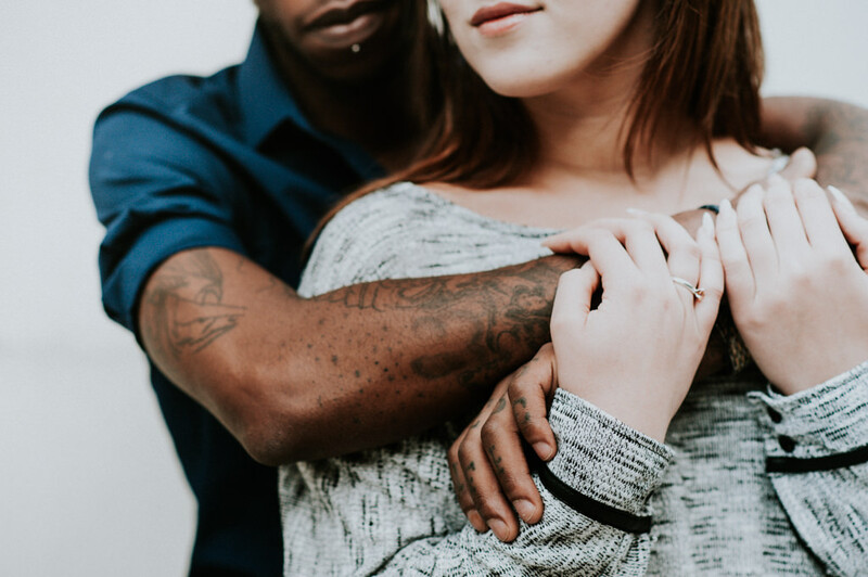 Young man hugging a young woman from behind