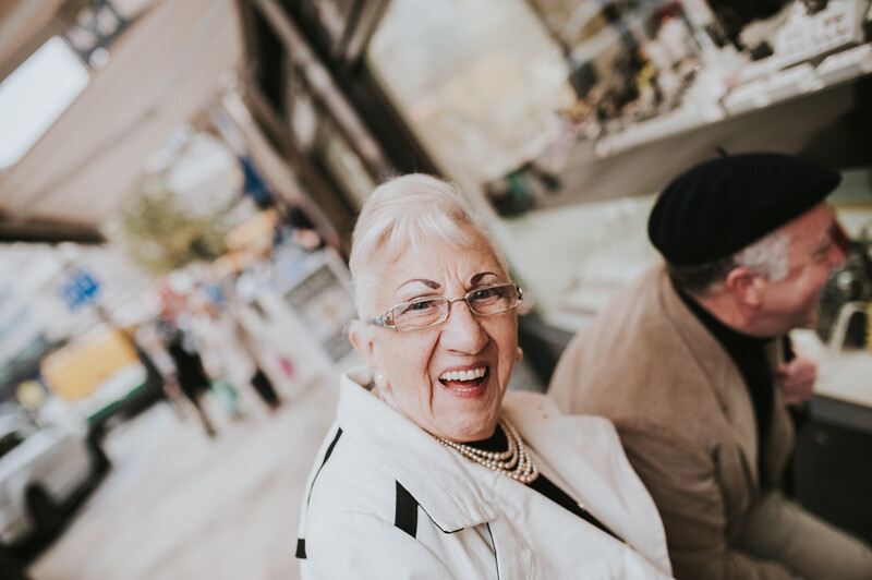 An older woman with glasses, smiling.