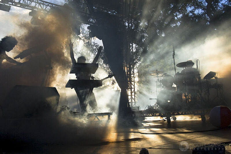 a photo of the band Future Rock playing on stage, with smoke and rays of light