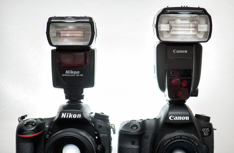 A size comparison between a Nikon SB-700 and the Canon 600EX-RT. The Canon 430EX III-RT is smaller still.