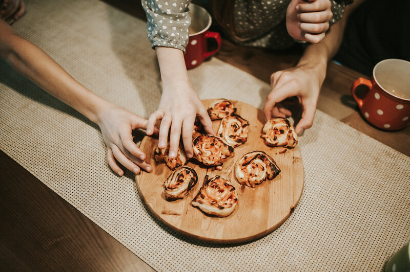 A family sharing a food platter. 