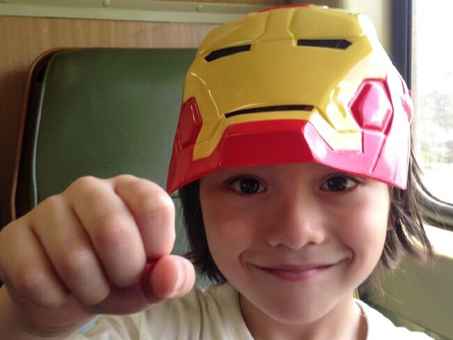 Julian Cadman wearing a Marvel Iron Man mask