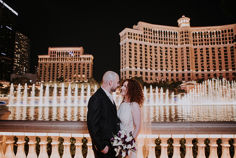 what to put in your portfolio bride and groom pose in front of bellagio fountains