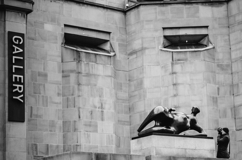 A man photographing an urban landscape.