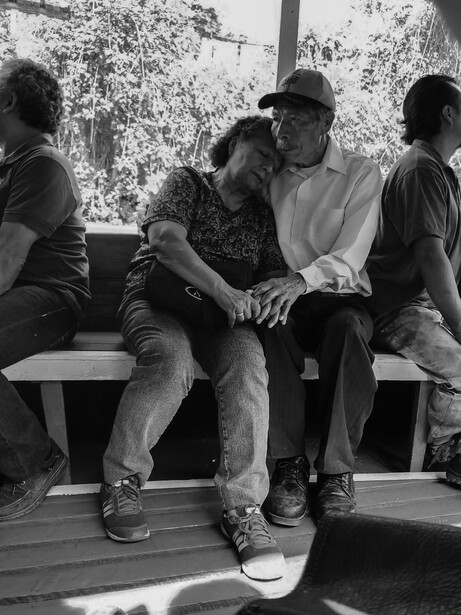 Street photograph of an elderly couple embracing