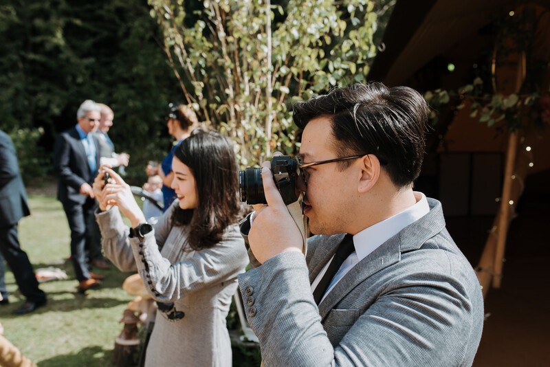 Wedding guests taking photographs